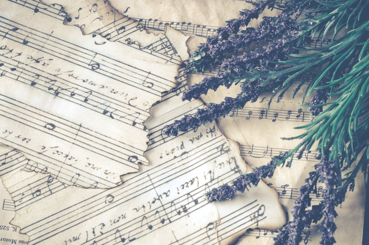 our-story Aesthetic composition of lavender flowers on old music sheets, evoking nostalgia.